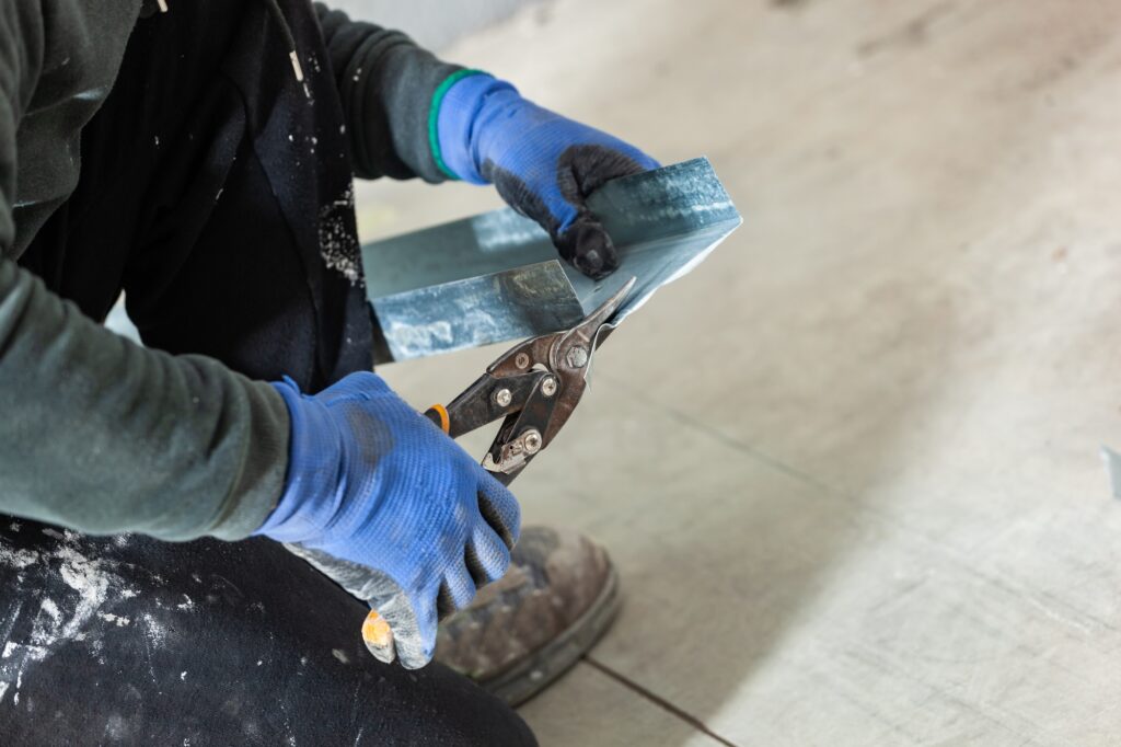 Worker builds a plasterboard wall.